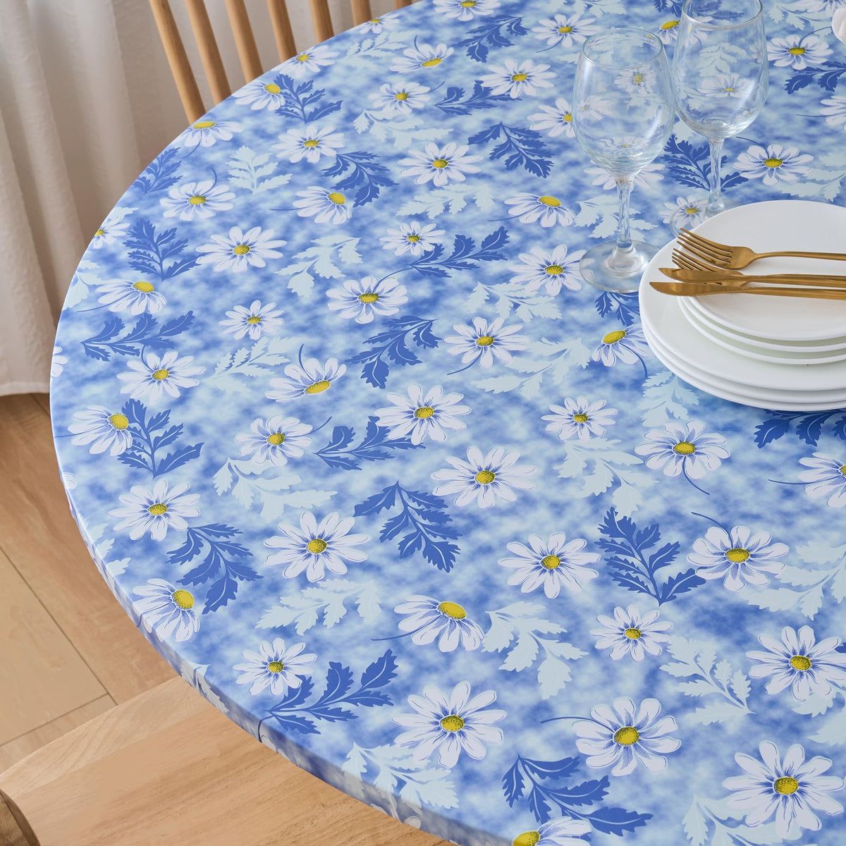 Pioggia elastic-edge tablecloth stays securely in place on an oval table