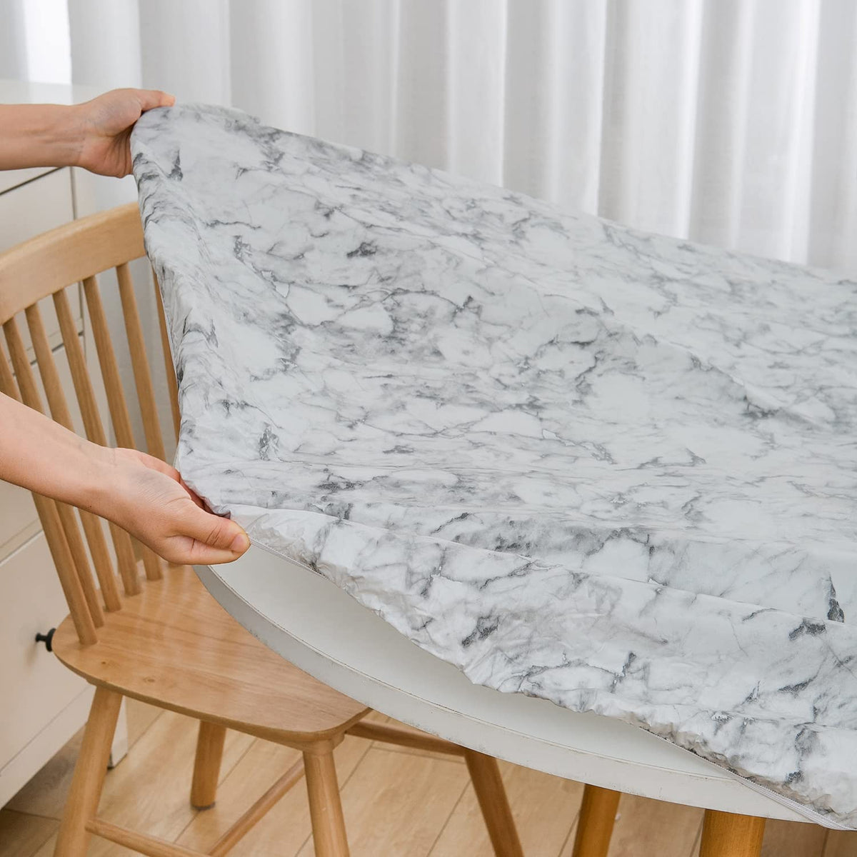 Pioggia elastic-edged oval tablecloth stays in place during meals.