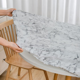 Pioggia elastic-edged oval tablecloth stays in place during meals.