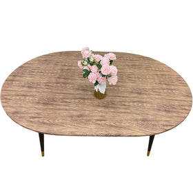 Pioggia oval vinyl fitted tablecloth with flannel backing on table, snugly protecting surface.