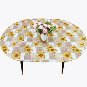 Pioggia oval vinyl fitted tablecloth with flannel backing protects surfaces during daily meals
