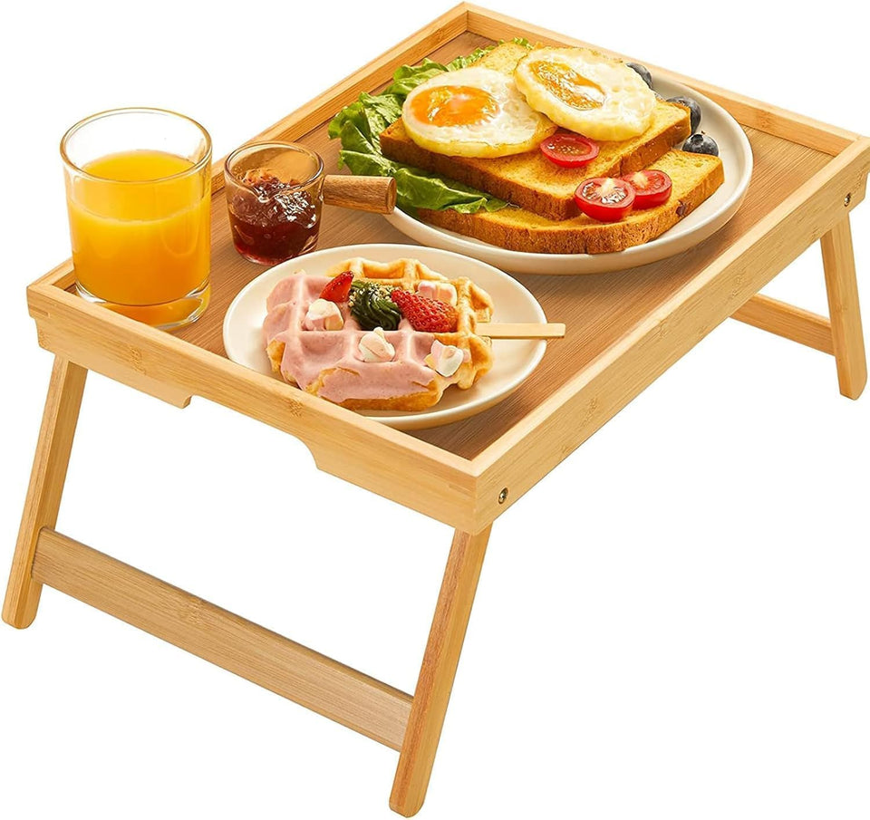 Pipishell bamboo bed tray with foldable legs provides a stable breakfast surface on a bed.