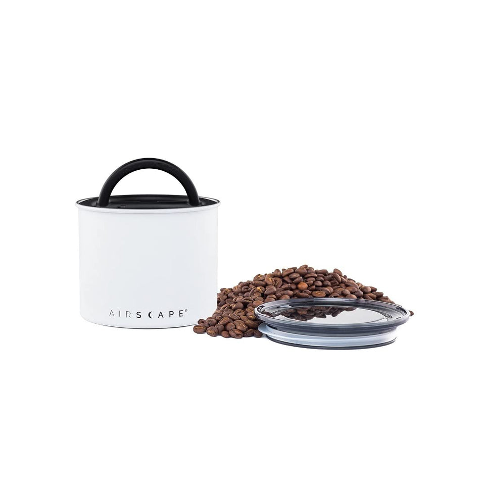 Planetary Design Airscape stainless steel canister demonstrates push-out-air action to preserve freshness.
