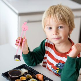 Plum Garden training chopsticks come in pink, yellow, blue, and black for color learning.
