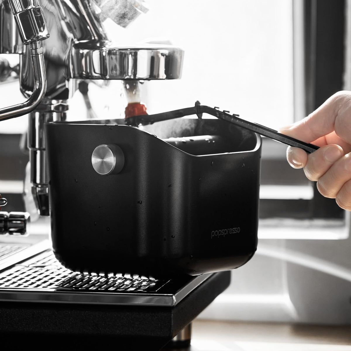 Popspresso knock box in a home cafe setup promoting tidy workflow.