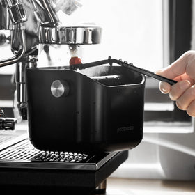 Popspresso knock box in a home cafe setup promoting tidy workflow.