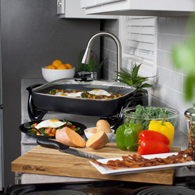 Presto 06852 skillet with heavy cast aluminum base demonstrates warp-proof durability for steady cooking.