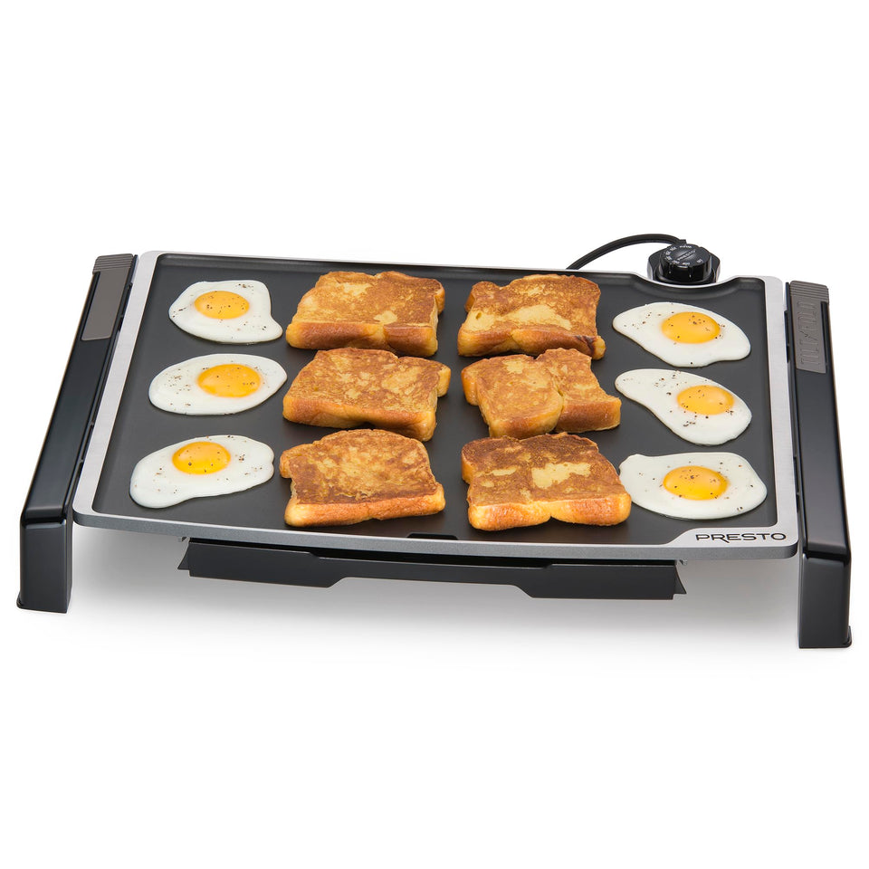 Presto 07073 XL tilt-fold electric griddle showing tilted surface for draining grease during cooking.
