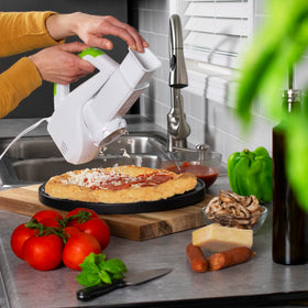 Presto Salad Shooter in action, slicing and shredding for fast meals
