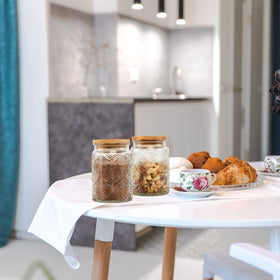 Prettidecor countertop organizer jars keep dry ingredients neatly accessible.