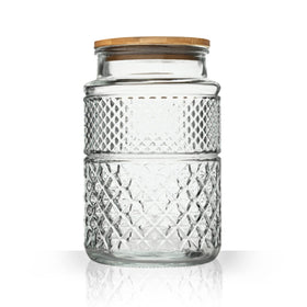 Prettidecor large glass storage jar on a shelf for pantry organization.