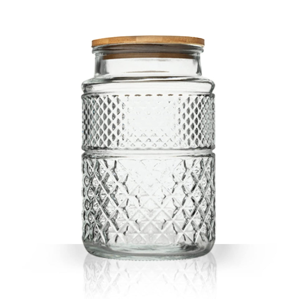 Prettidecor large glass storage jar on a shelf for pantry organization.