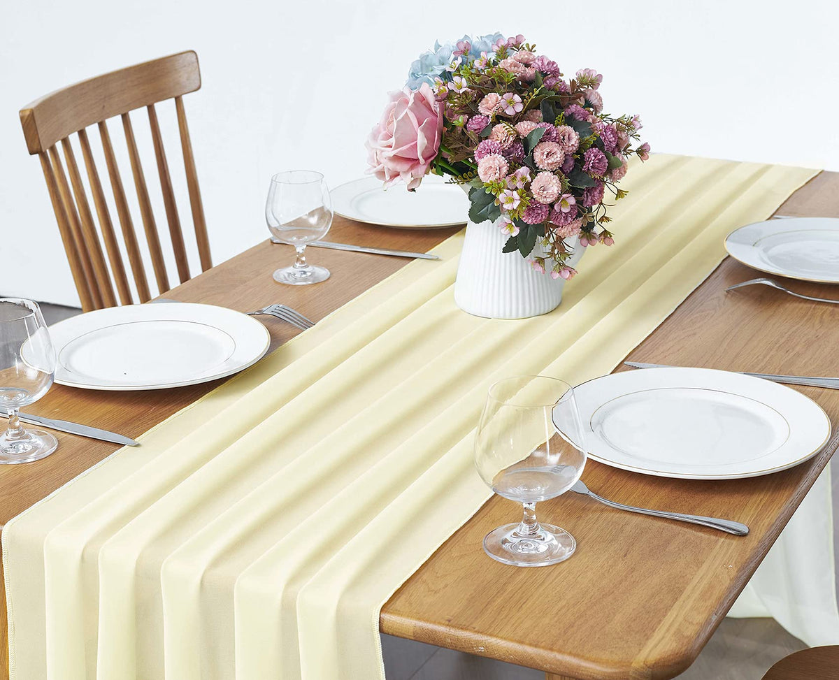 Pufogu light yellow chiffon table runner cascading over a banquet table.
