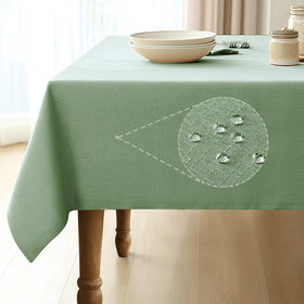 Pureegg rectangle tablecloth in sage green with water-repellent fabric for spill protection.