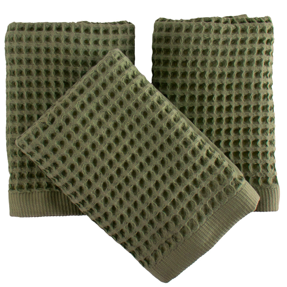 PÜSKÜL waffle towels folded in khaki green showing soft quick-dry texture.