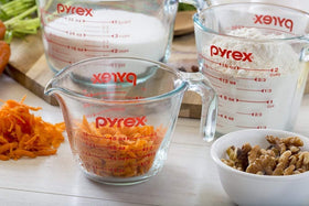 Pyrex Essentials cups display bold red measurements for quick, accurate prep.