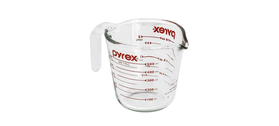 Pyrex Prepware measuring cup with red graphics for precise liquid measurements.