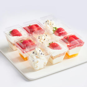 Qeirudu dessert cups with clear lids display layered puddings and parfaits vividly.