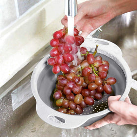 QiMH colander with ergonomic handles for comfortable draining.