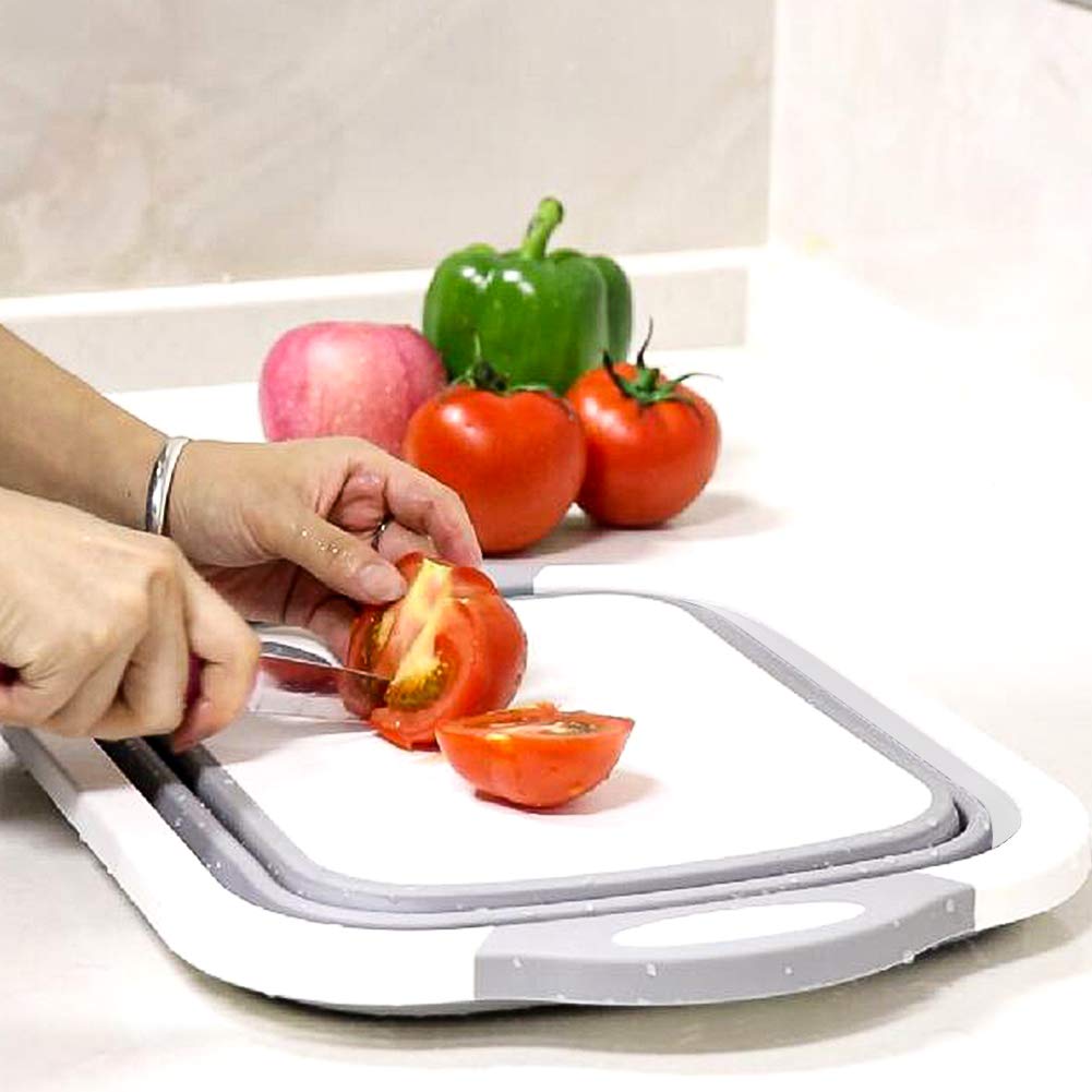 QiMH collapsible board used as a camping essential beside a camping stove.