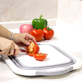 QiMH collapsible board used as a camping essential beside a camping stove.