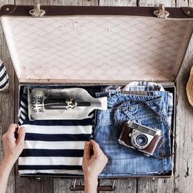 QPEY bottle protector sleeve safeguards fragile bottles in luggage.