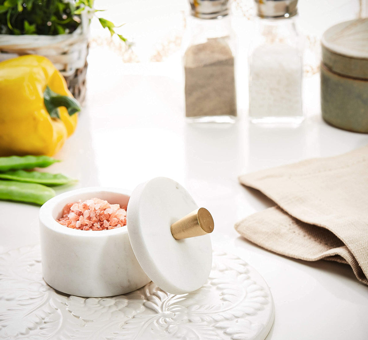Queenza marble lid with brass knob seals contents for lasting freshness.