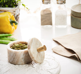 Queenza marble salt cellar lid open shows brass knob detail and easy access.