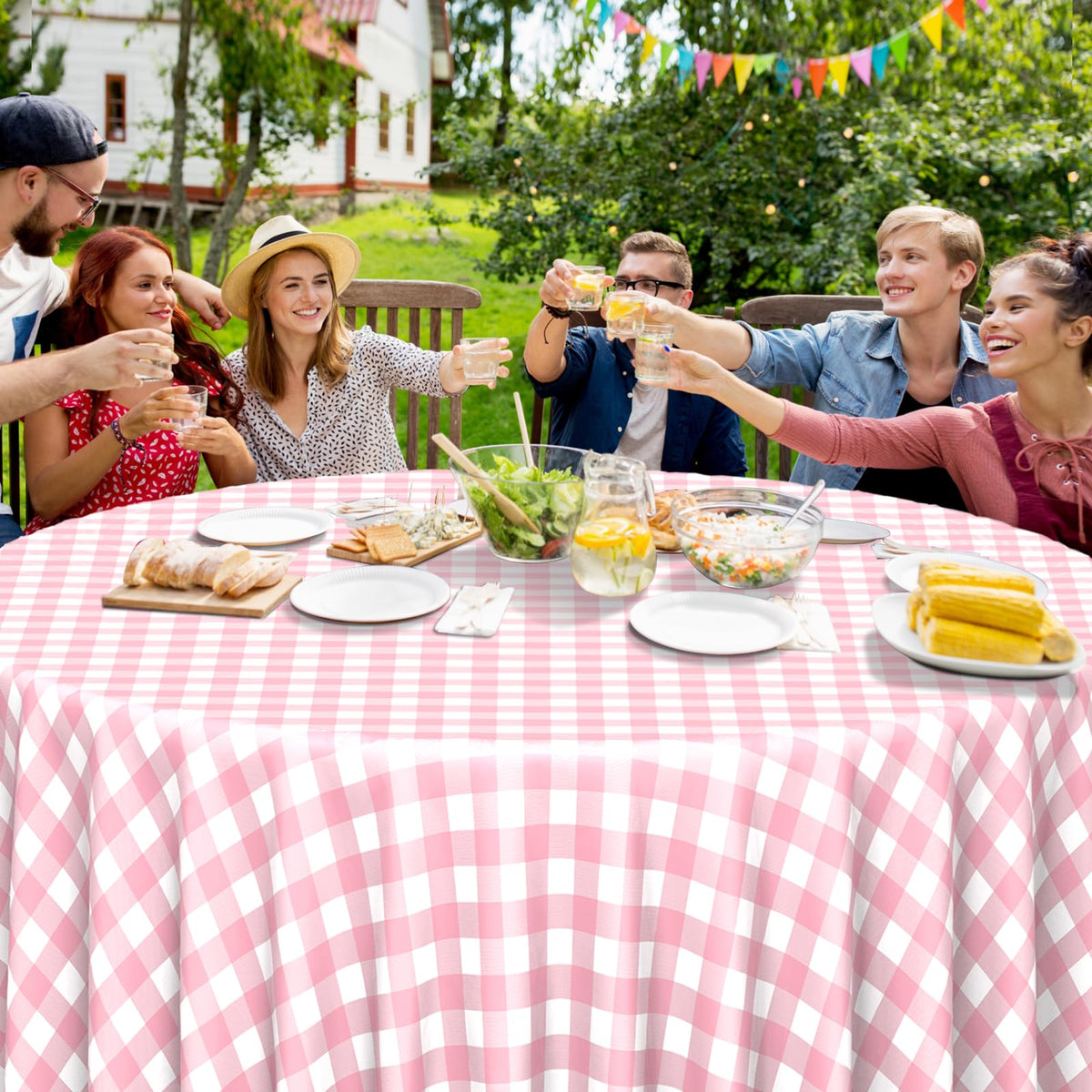 Ragnhild pink-white round gingham tablecloth used for an outdoor picnic scene.