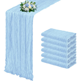 RealBox baby blue cheesecloth table runner drapes elegantly on a rustic wedding table.