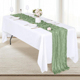 Rustic wedding table setup featuring RealBox sage green runners.