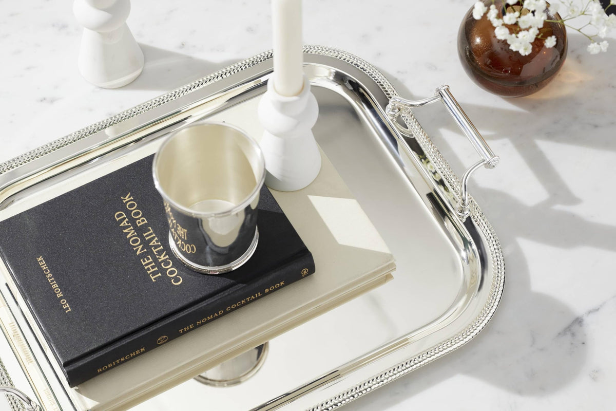 Reed & Barton tray shows baroque handles for an elevated serving look.