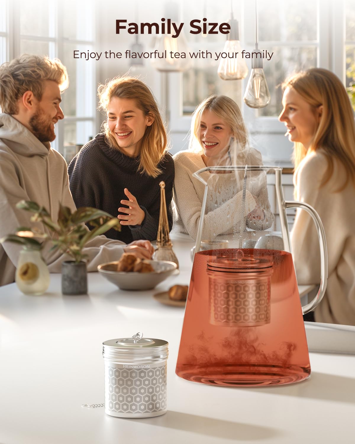 Large tea infuser perched on pitcher rim during brewing.