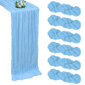 RestfulGlow six-pack baby blue cheesecloth table runner laid across a long dining table for romantic boho ambiance