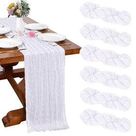 RestfulGlow six-pack white cheesecloth table runner laid on a long banquet table.