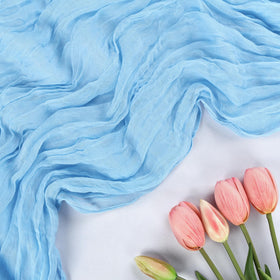 RestfulGlow baby blue runner draped over an arch for a boho wedding ceremony