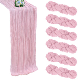 RestfulGlow pink cheesecloth table runner draped on a wedding table for romantic texture.