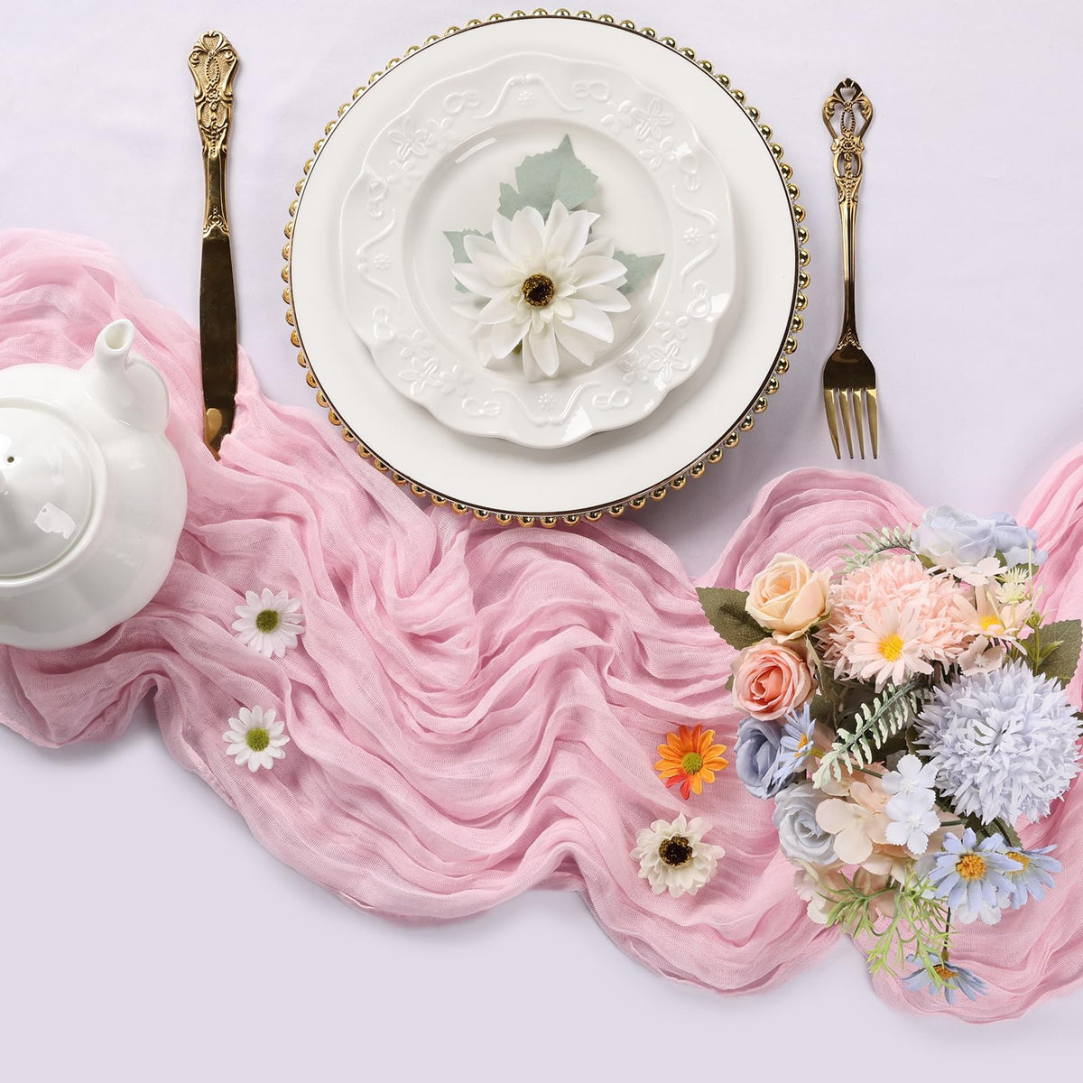 RestfulGlow pink cheesecloth table runner on a long banquet table for boho chic ambiance.