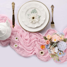 RestfulGlow pink cheesecloth table runner on a long banquet table for boho chic ambiance.