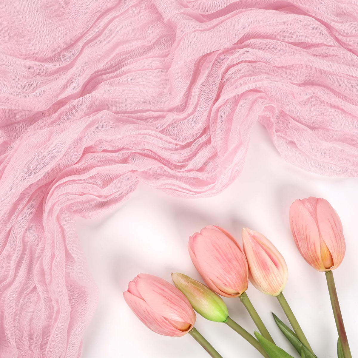 RestfulGlow pink cheesecloth table runner arranged as ceiling drape for event décor.
