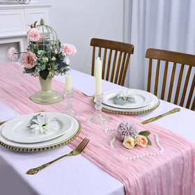 RestfulGlow pink cheesecloth table runner used as chair sash for rustic weddings.