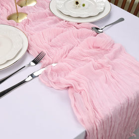 RestfulGlow pink cheesecloth table runner brightens birthday party tables with sheer layers.
