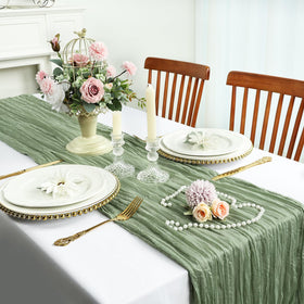 Rustic table decoration with sage-green RestfulGlow cheesecloth runner.