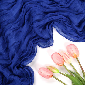 RestfulGlow wedding setup with royal blue cheesecloth runners for boho chic style.