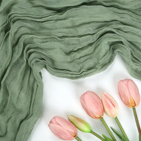 Wedding table decor using RestfulGlow sage-green runner as backdrop.