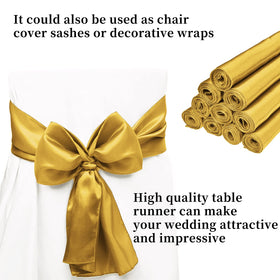 REWOMC wedding table setup with gold satin runner for elegance.