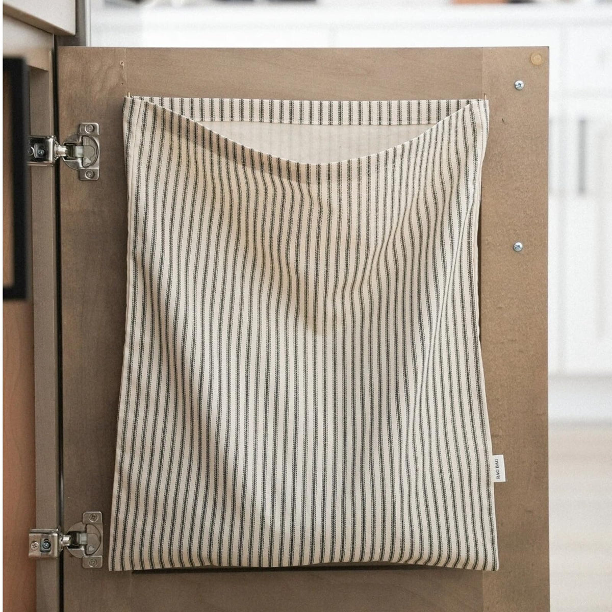 Ribbonlic bag rag cloth holder hanging on a kitchen hook for easy towel access.