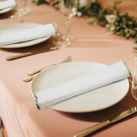 Ridhi sage edge detail on napkins adds a refined table styling touch.