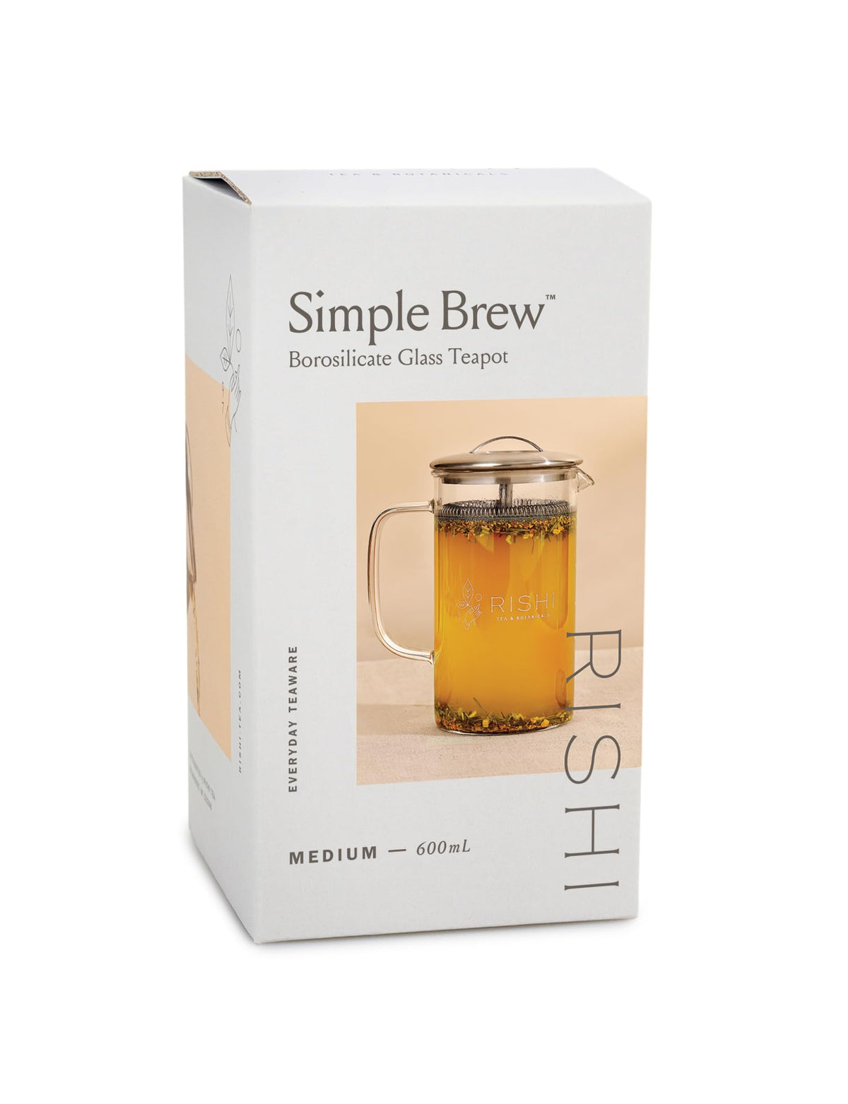 Pouring hot tea from the Rishi Tea Simple Brew teapot into a cup.