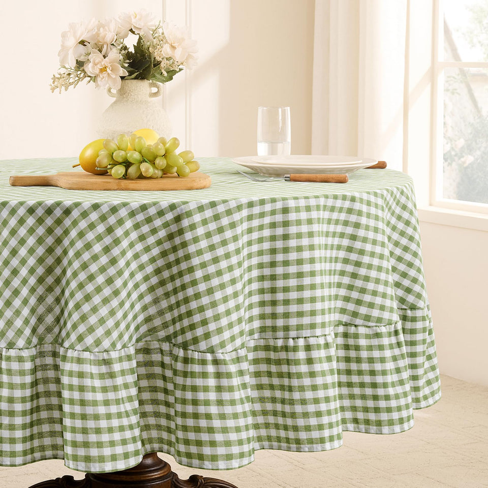 Romanstile gingham-ruffled round tablecloth in sage adds elegant outdoor charm.